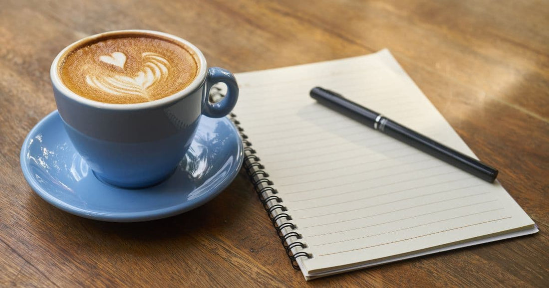 Fresh cup of coffee with latte art on table, representing coffee benefits and daily routine